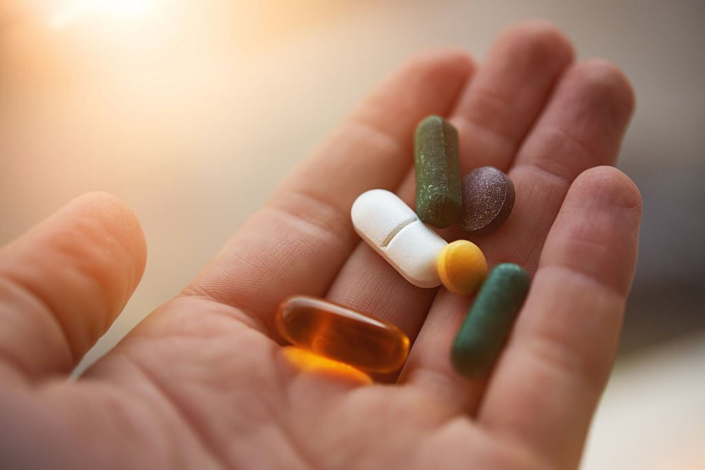 man hand holding his nutritional supplemets, healthy lifestyle background.