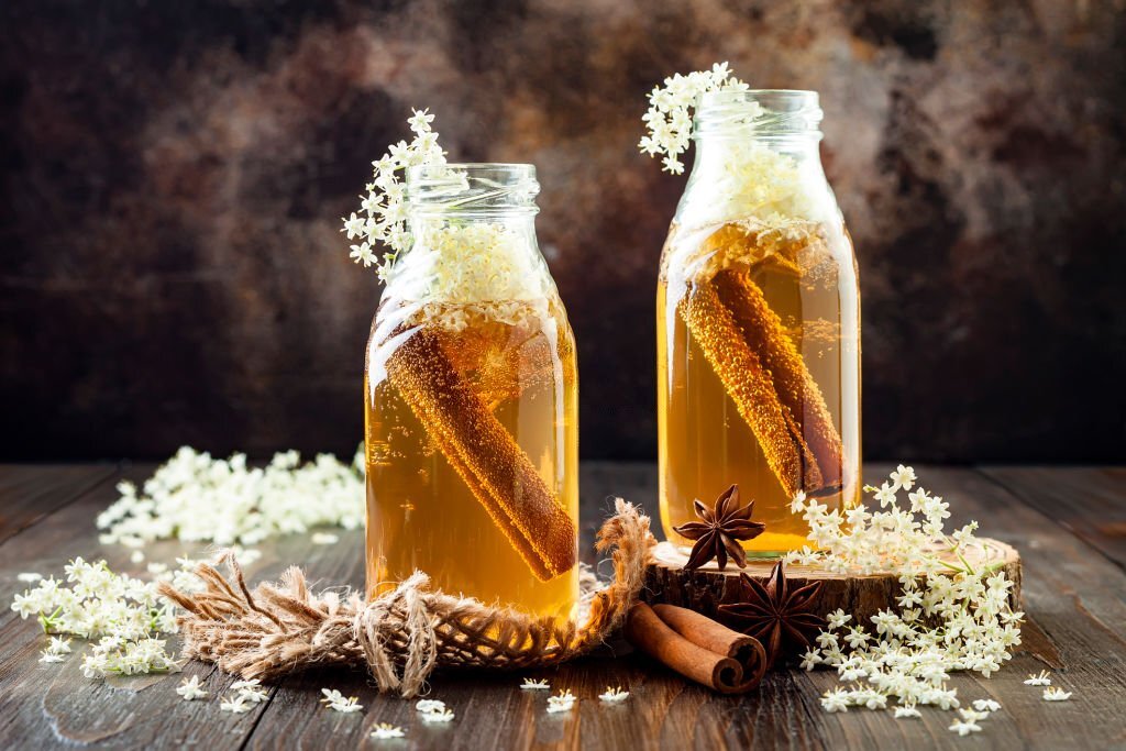 Homemade fermented cinnamon and ginger kombucha tea infused with elderflower. Healthy natural probiotic flavored drink. Copy space