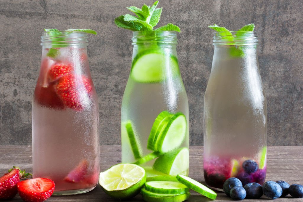 Variety of cold summer drinks in small bottles. detox water