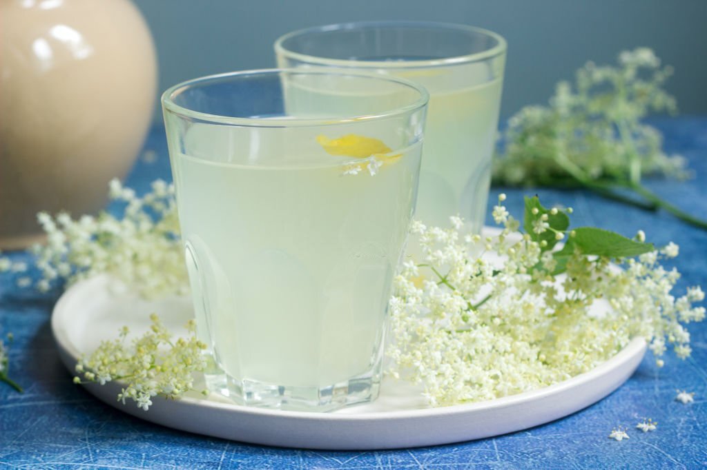 Cold sokata - a traditional Romanian drink made from the flowers of elder and lemon, produced by fermentation. Selective focus.