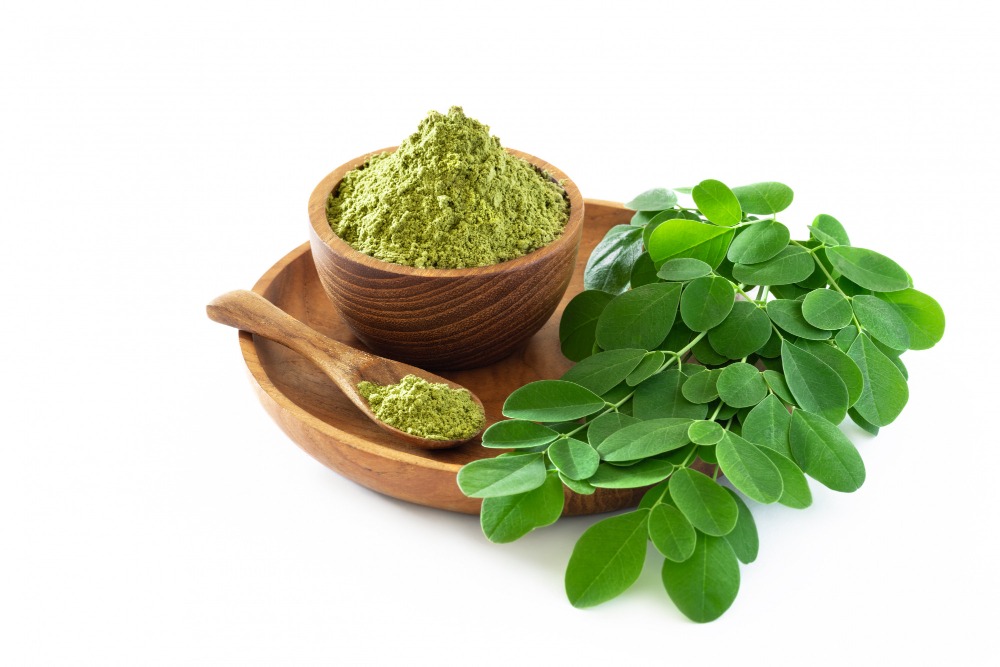 moringa-powder-wooden-bowl-with-original-fresh-moringa-leaves-isolated-white-background